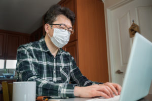 An Asian man who is self-isolated and working from home because of a massive pandemic.