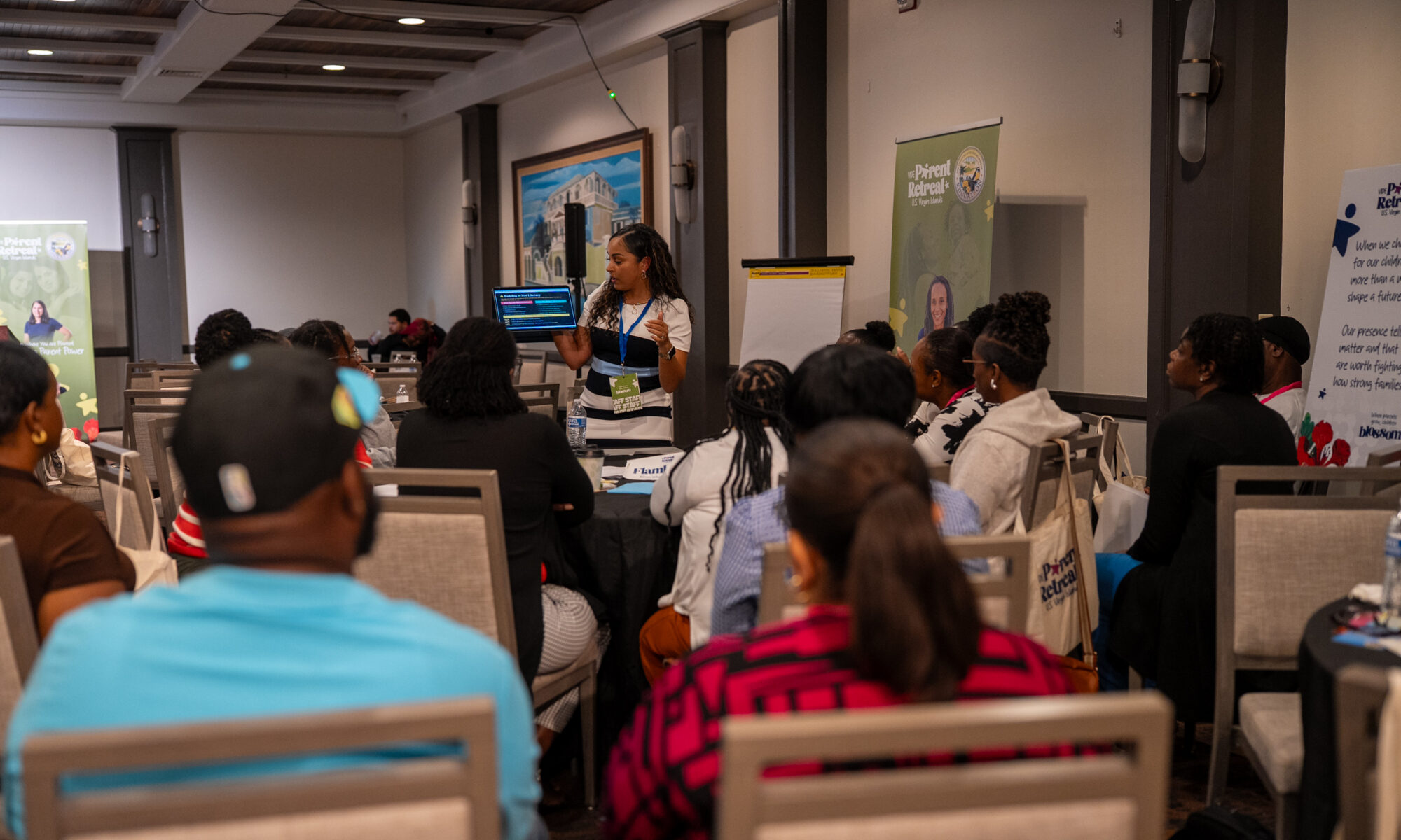 Speaker presents to a crowd of people at the parent retreat.