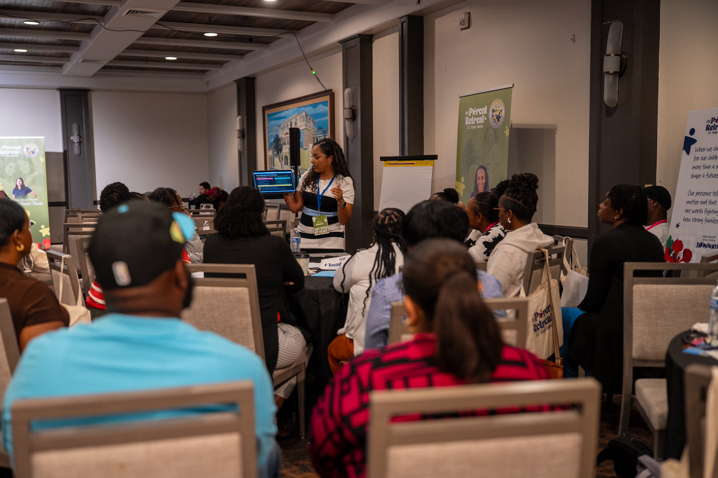 Speaker presents to a crowd of people at the parent retreat.